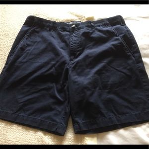 Men’s flat front dark blue shorts.